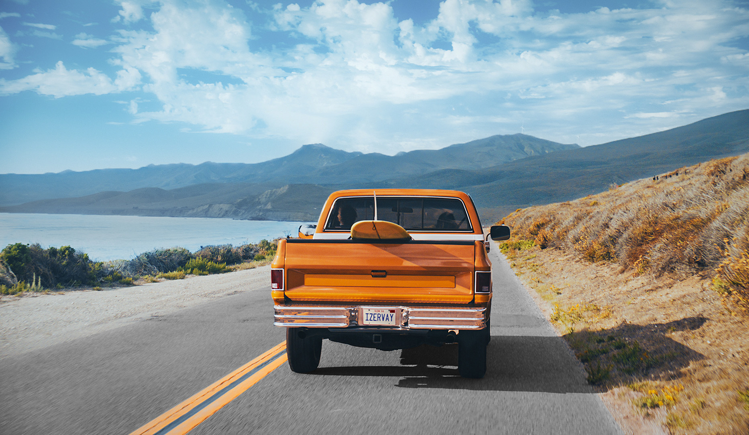 Image of orange truck driving away