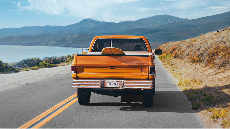 Image of orange truck driving away