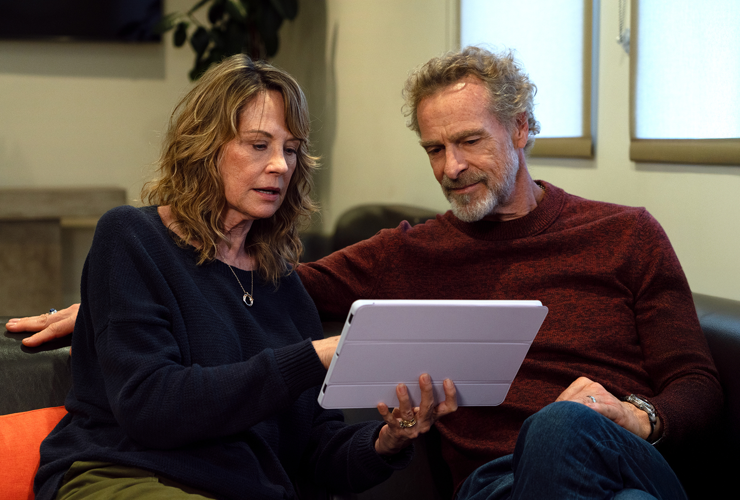 Image of woman and man looking at iPad