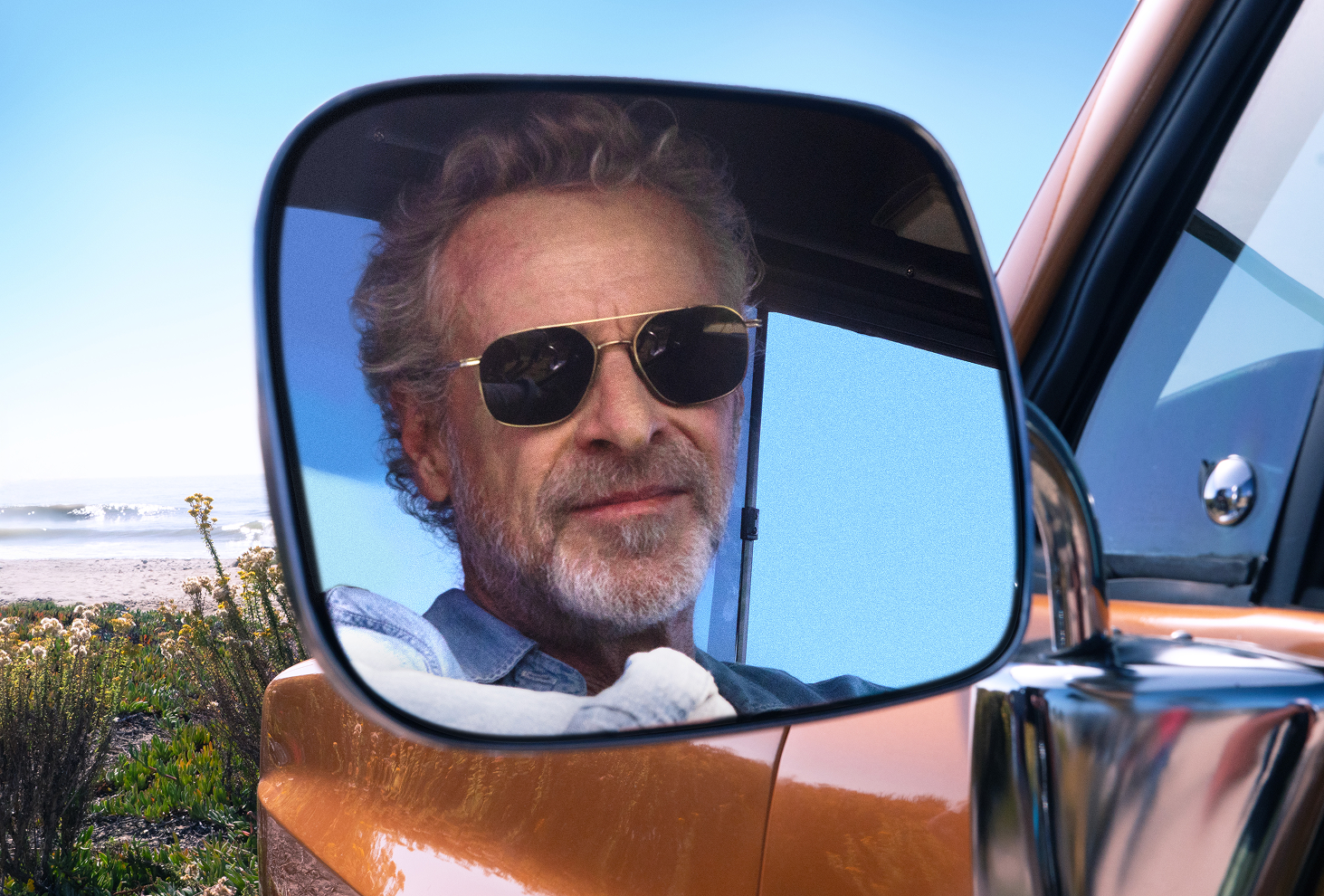 Man looking in side-view mirror